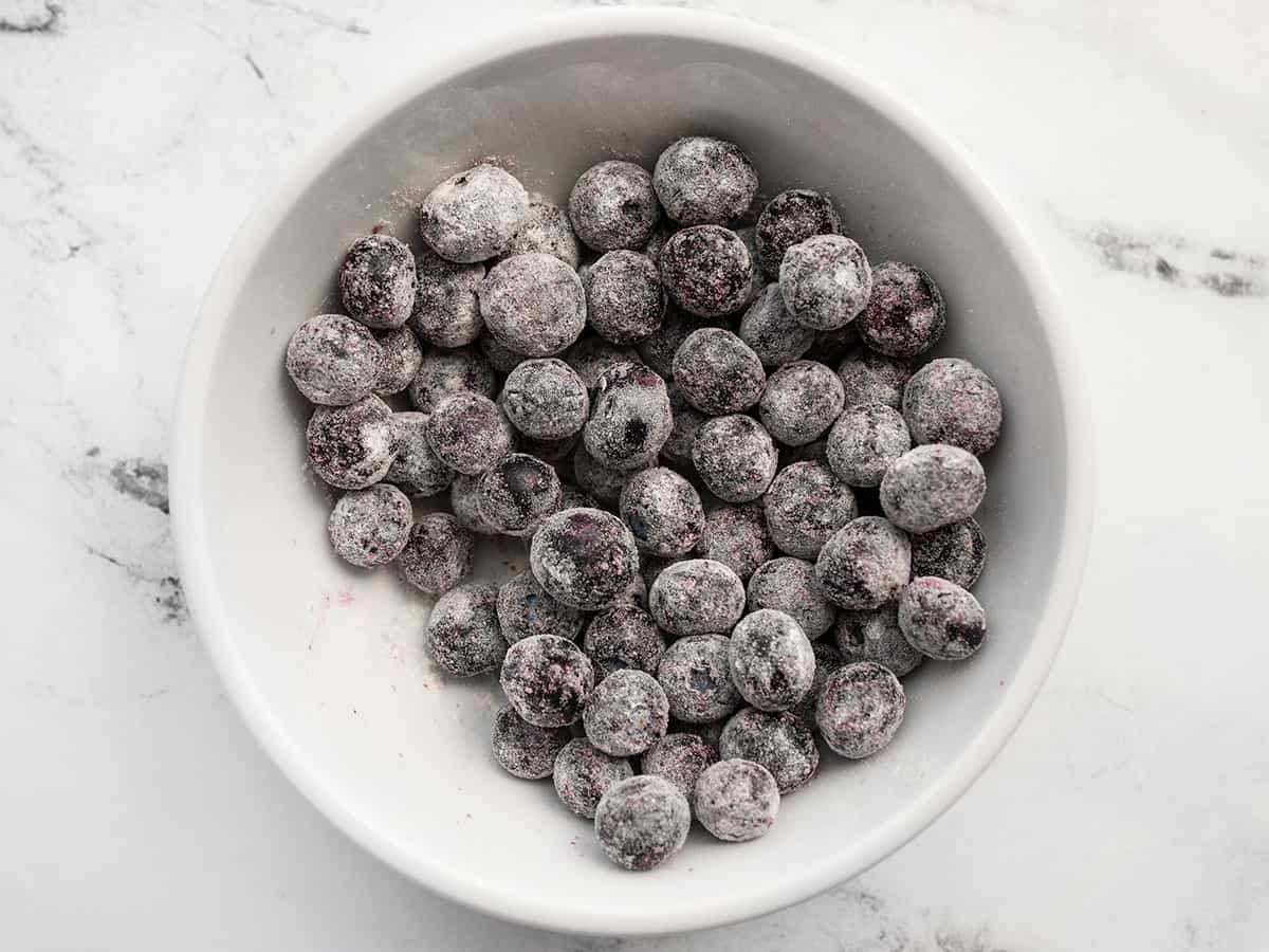 A bowl of blueberries coated in flour.