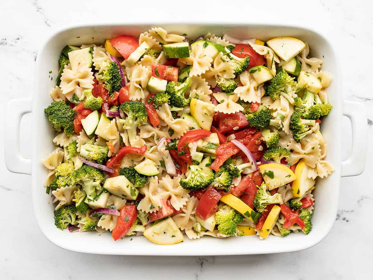 Finished summer vegetable pasta salad in a large casserole dish