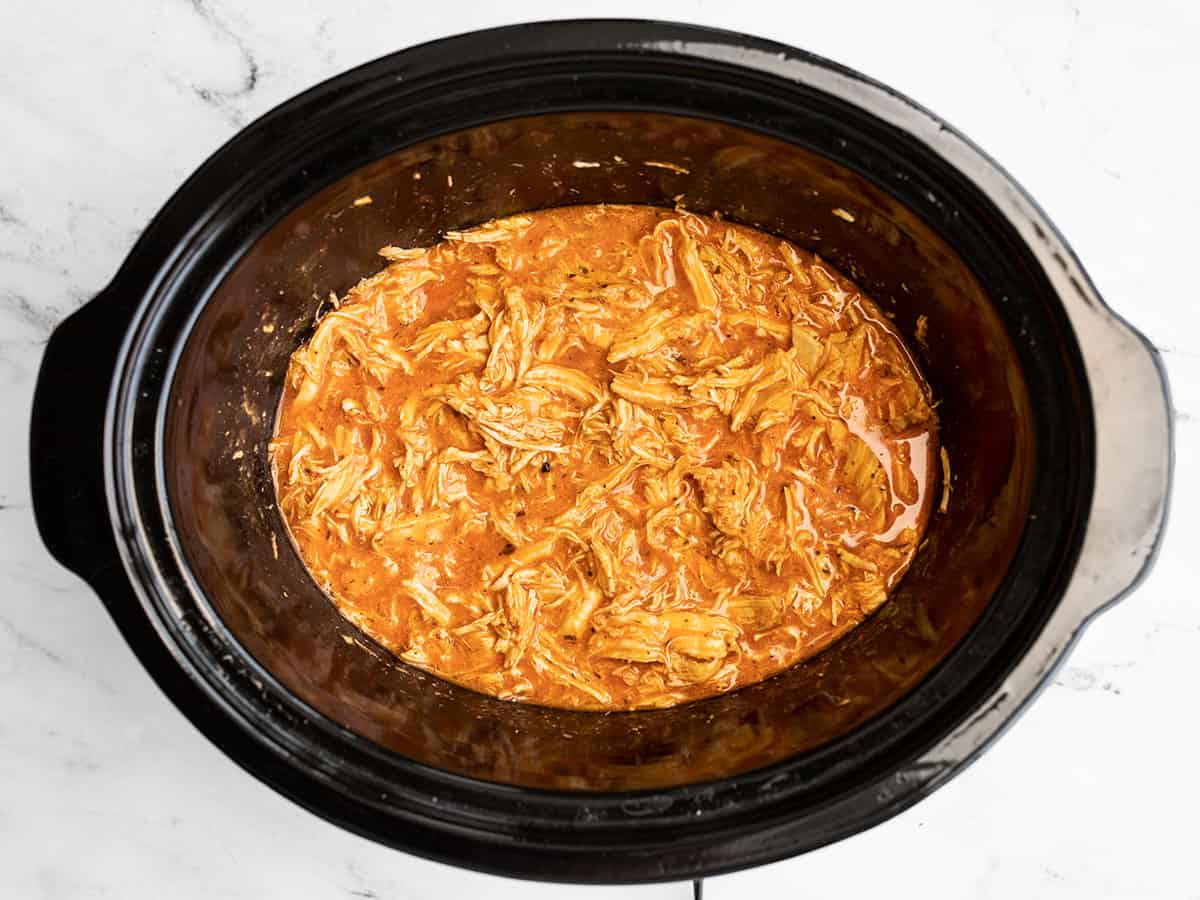 shredded chicken in buffalo sauce in the slow cooker