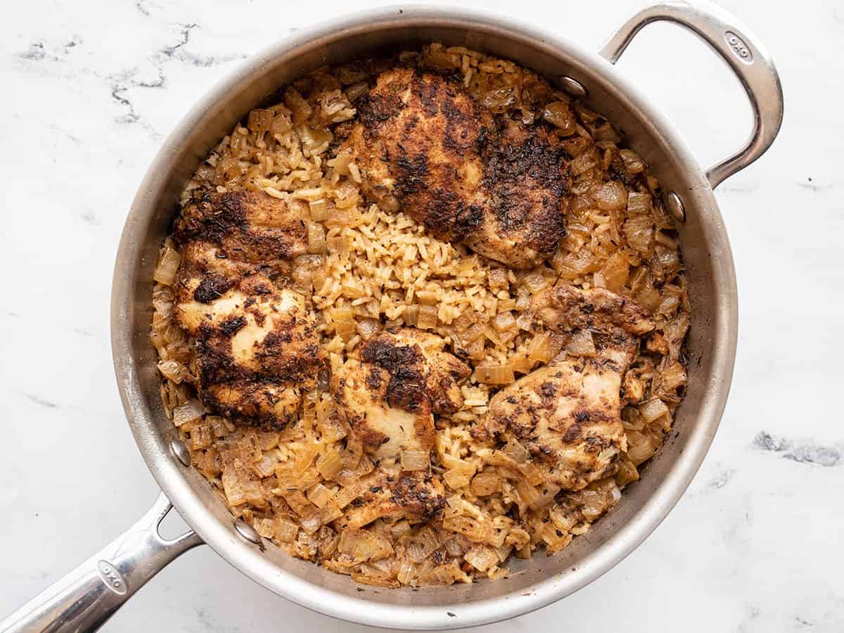 Cooked chicken and rice in the skillet.