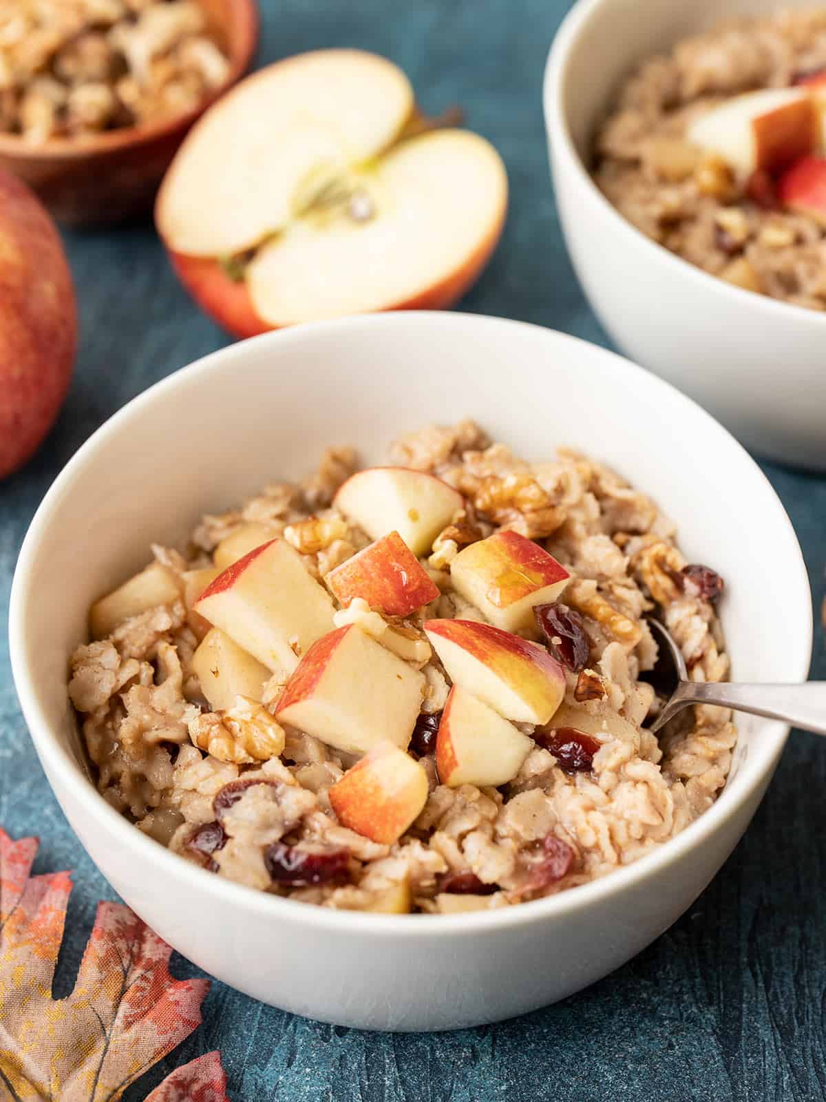 Side view of two bowls of autumn fruit and nut oatmeal