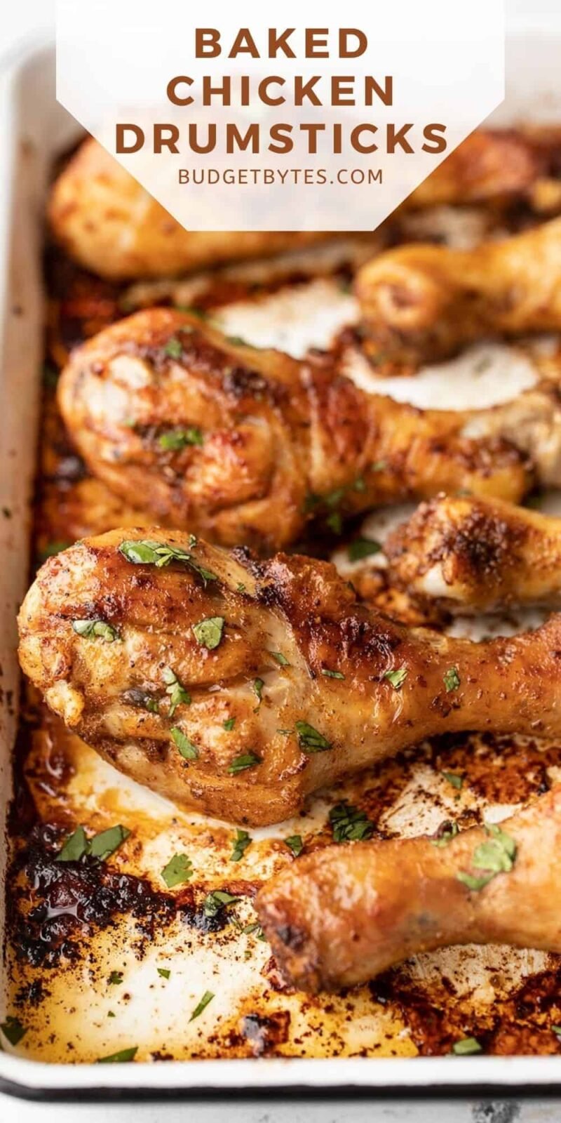 Side view of baked chicken drumsticks on a baking sheet, title text at the top