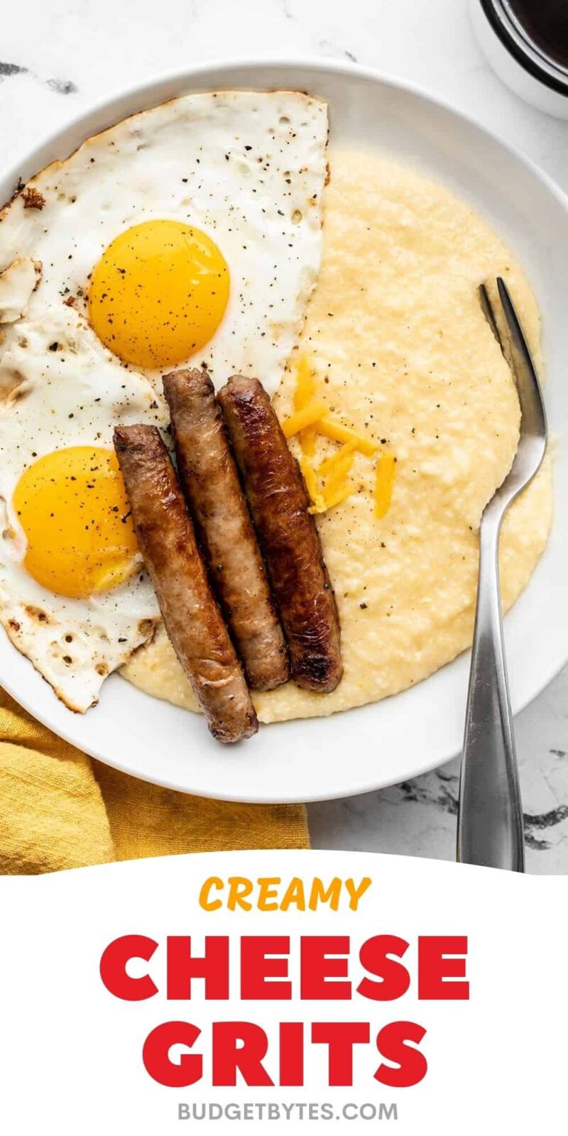 cheese grits on a plate with eggs and sausage, title text at the bottom