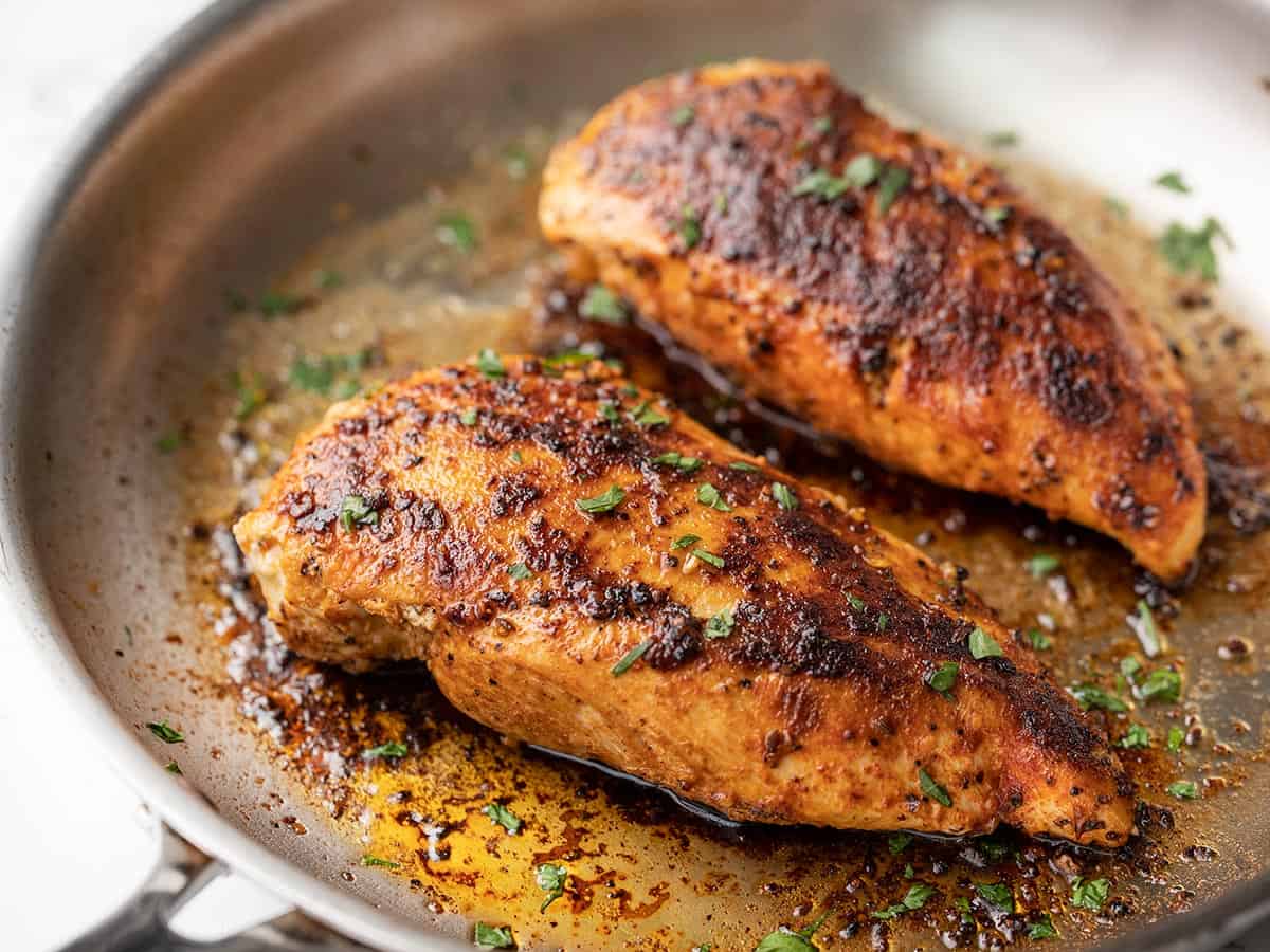 side view of chicken breasts in a skillet