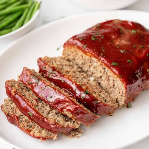 Side view of sliced meatloaf on a platter