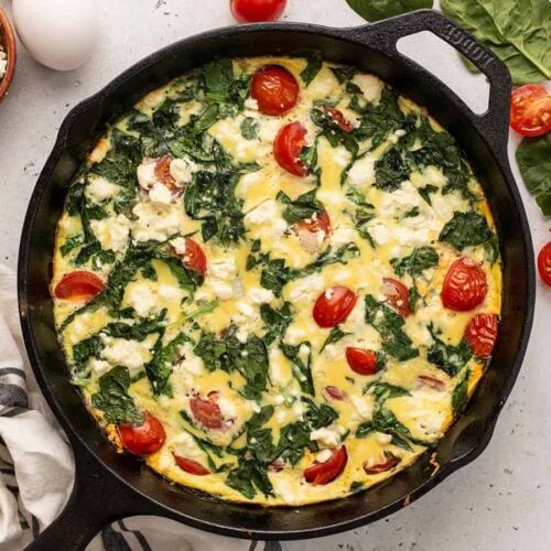 Overhead view of a spinach and tomato frittata