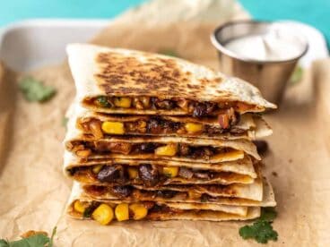 A stack of black bean quesadillas on a serving tray