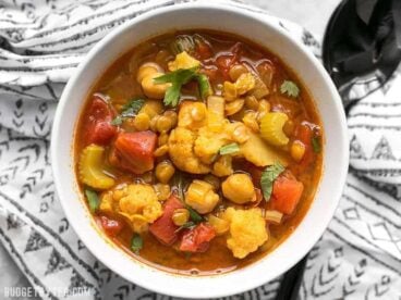 Warm intoxicating spices make this vegetable filled Moroccan Lentil and Vegetable Stew perfect for cold Autumn nights. BudgetBytes.com