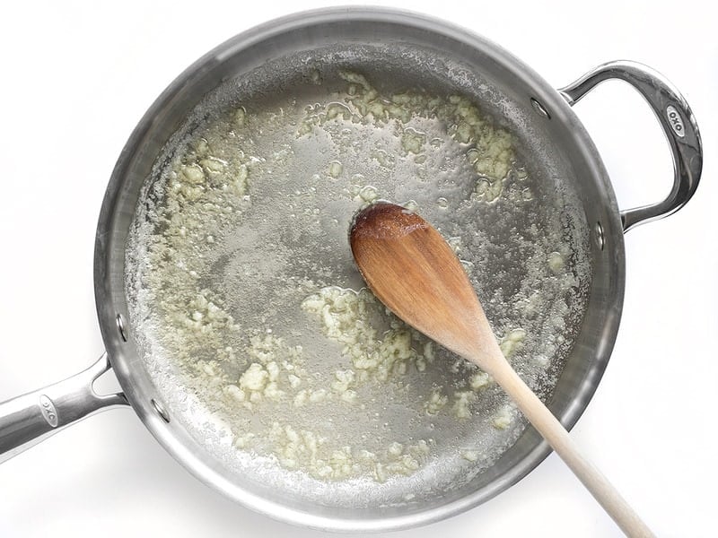 Sautéed Garlic in butter, in a deep skillet with wooden spoon