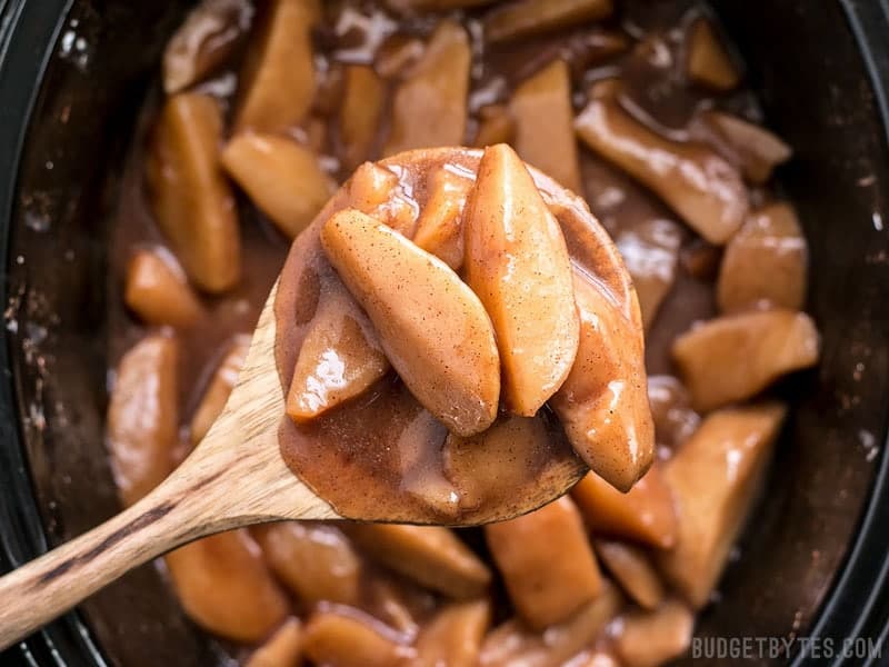 Close up of a spoonful of Slow Cooker Hot Buttered Apples 