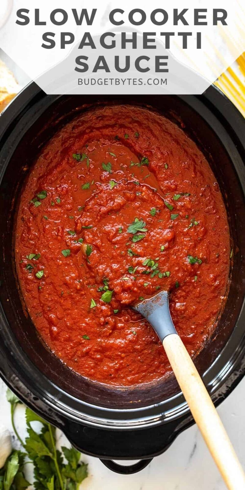 Overhead view of spaghetti sauce in the slow cooker, title text at the top