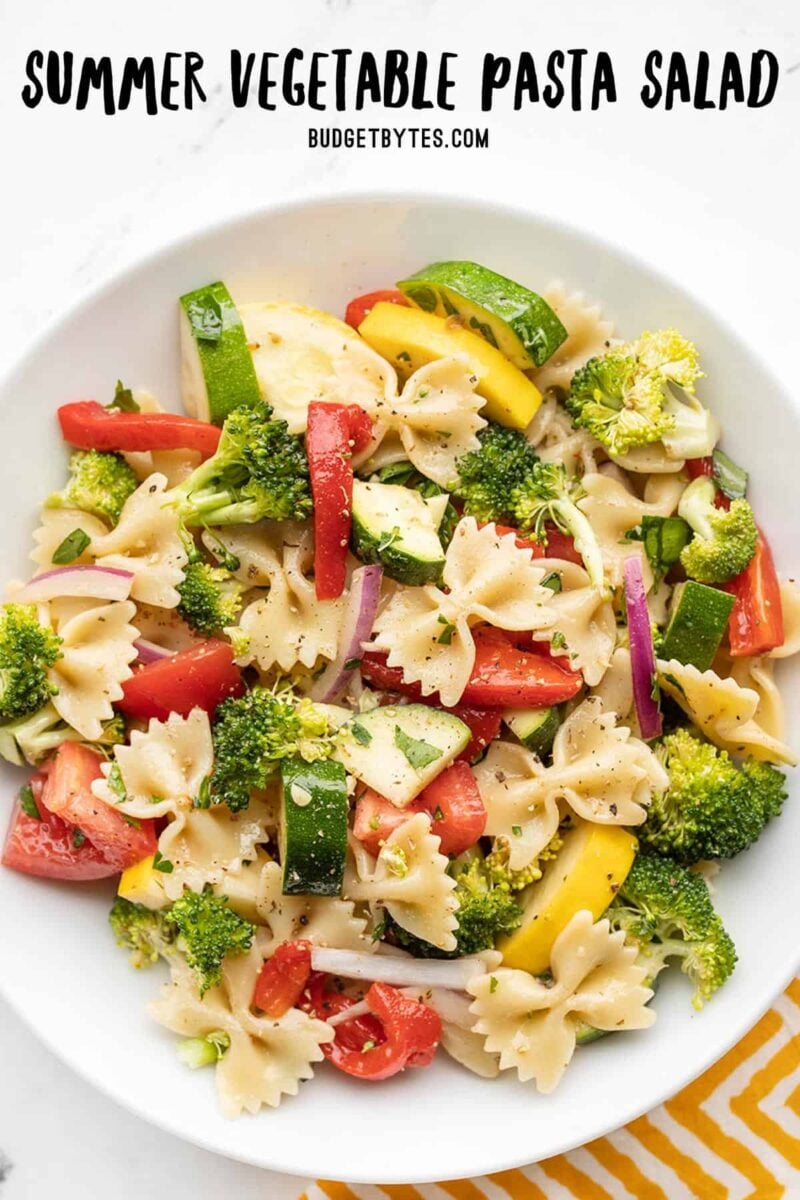 A bowl of summer vegetable pasta salad from above, title text at the top