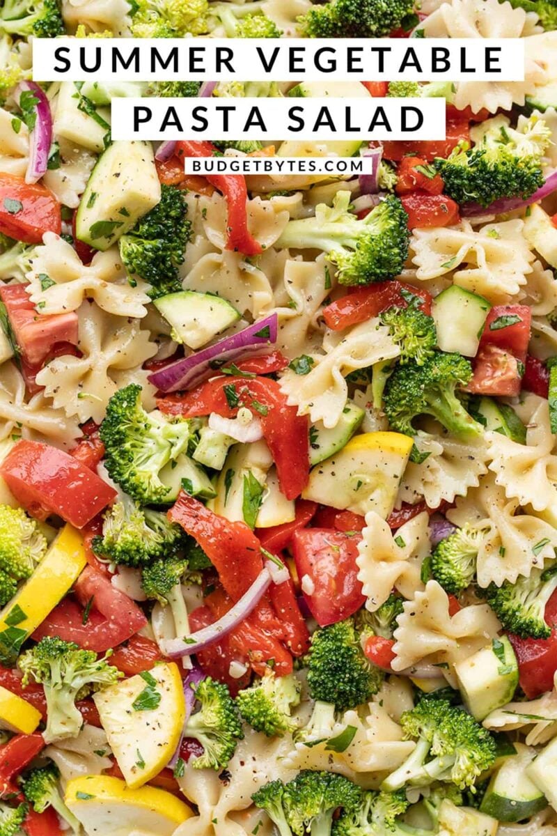 close up of summer vegetable pasta salad with title text at the top